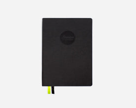 Black mid-year planner with a Passion Planner logo on a white background
