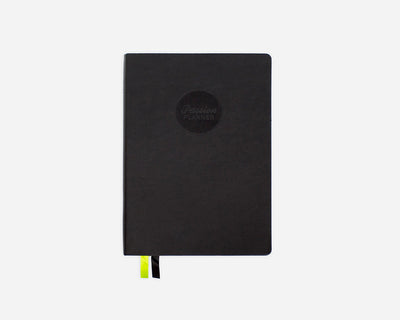 Black mid-year planner with a Passion Planner logo on a white background