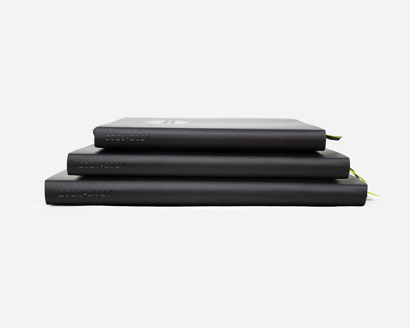 Three black planners stacked with 2026-2027 debossed on the spines on a white background
