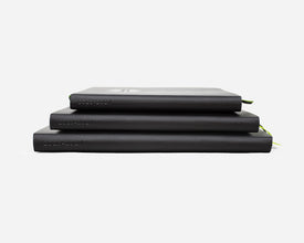 Three black planners stacked with 2026-2027 debossed on the spines on a white background