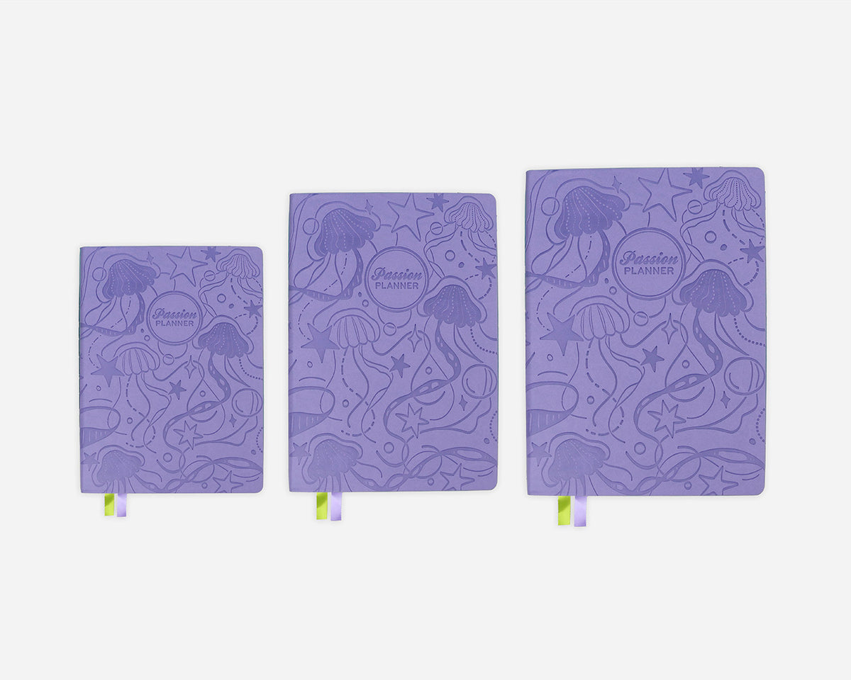 Three purple planners with jellyfish pattern on a white background