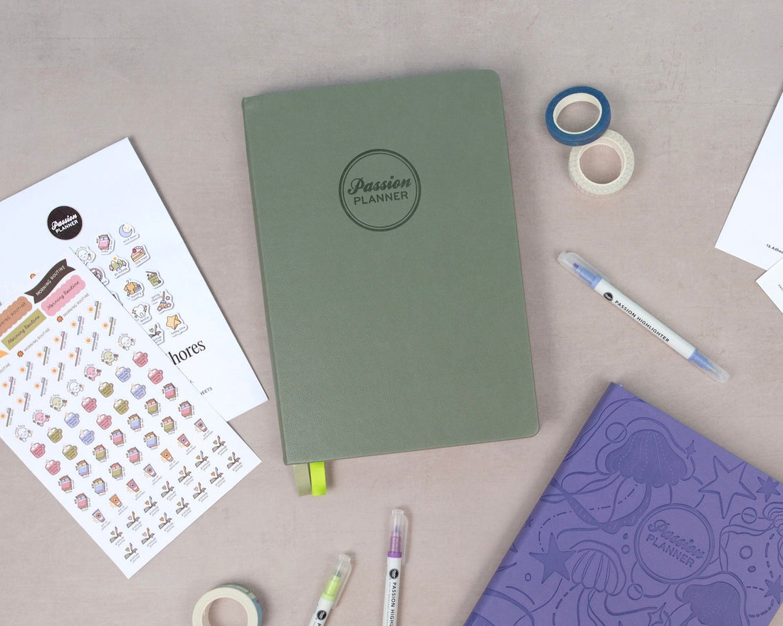 Notebooks, stickers, and pens on a beige surface