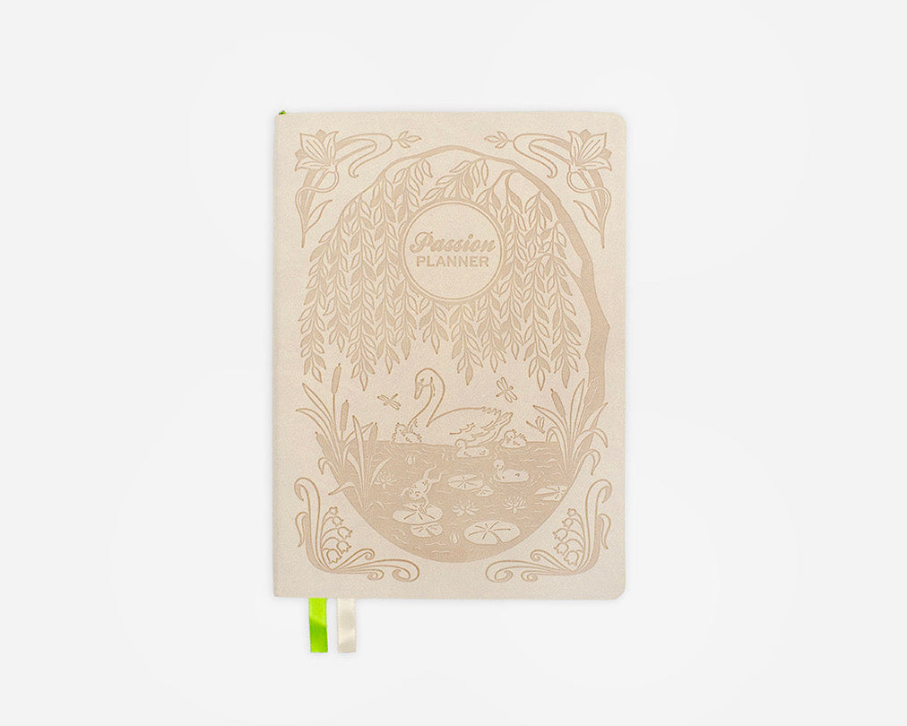 Decorative cream colored weekly planner with a swan design on a white background