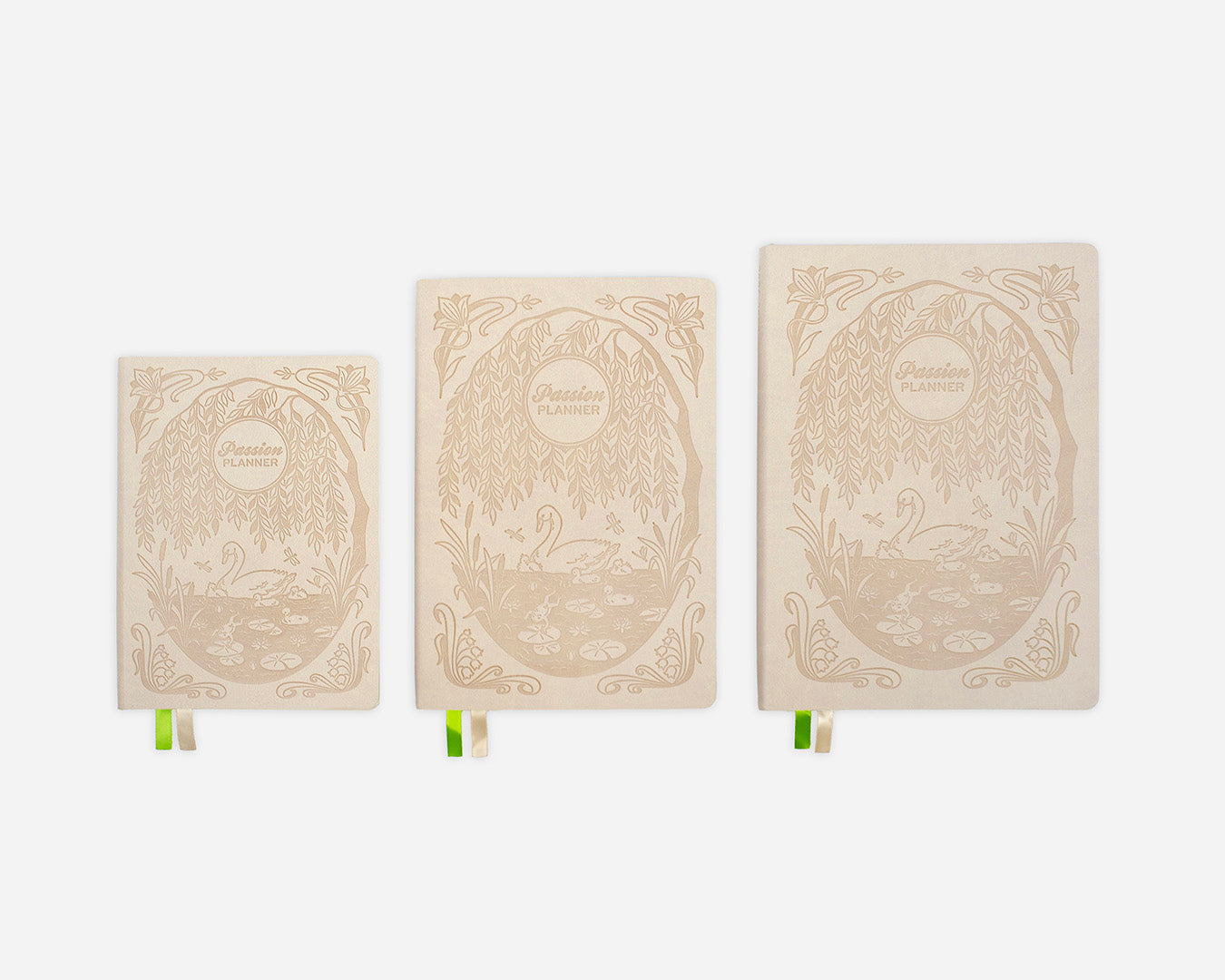 Three decorative cream notebooks with intricate swan design on a white background
