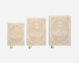 Three decorative cream notebooks with intricate swan design on a white background