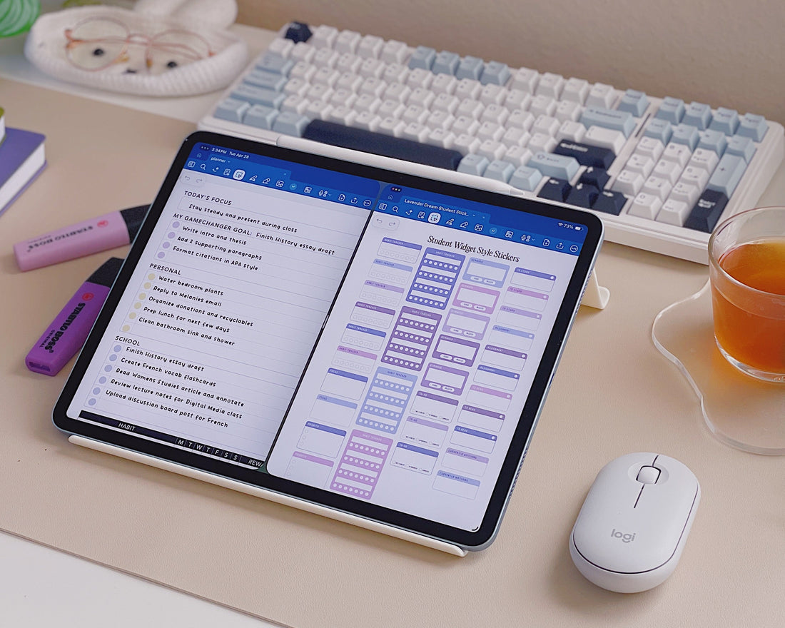 Desk setup with tablet, keyboard, mouse, and tea cup on a desk.