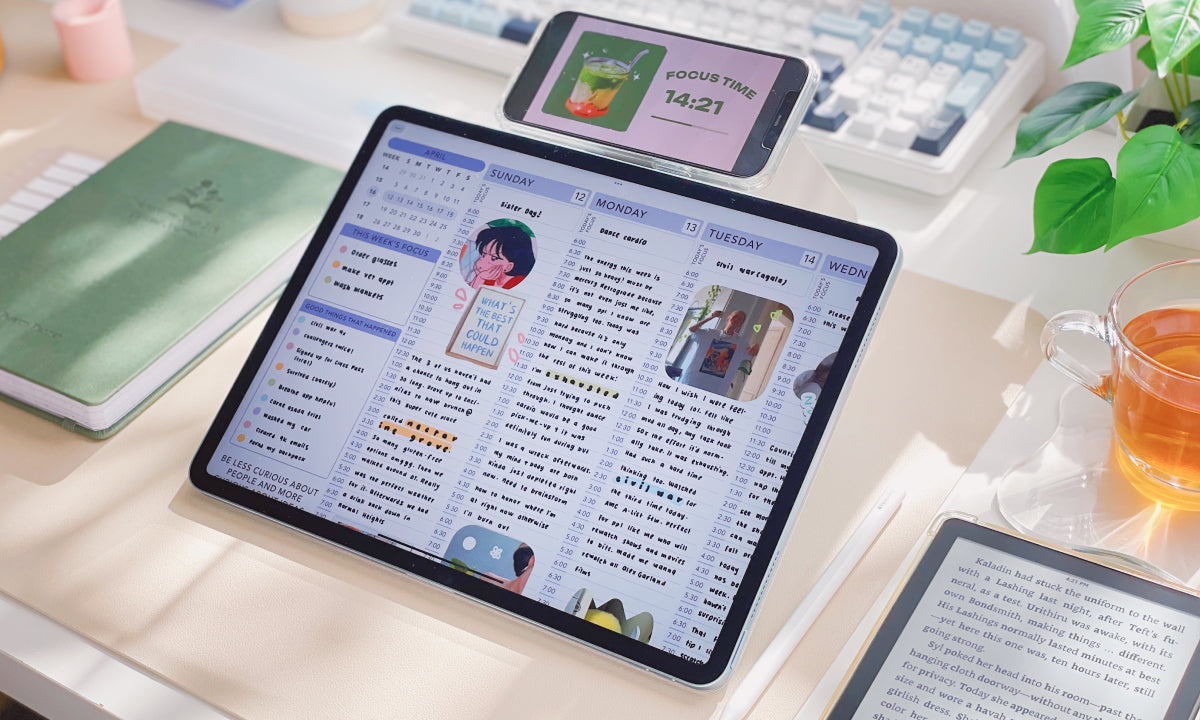 Tablet displaying a digital planner on a desk with a keyboard and notebook in the background