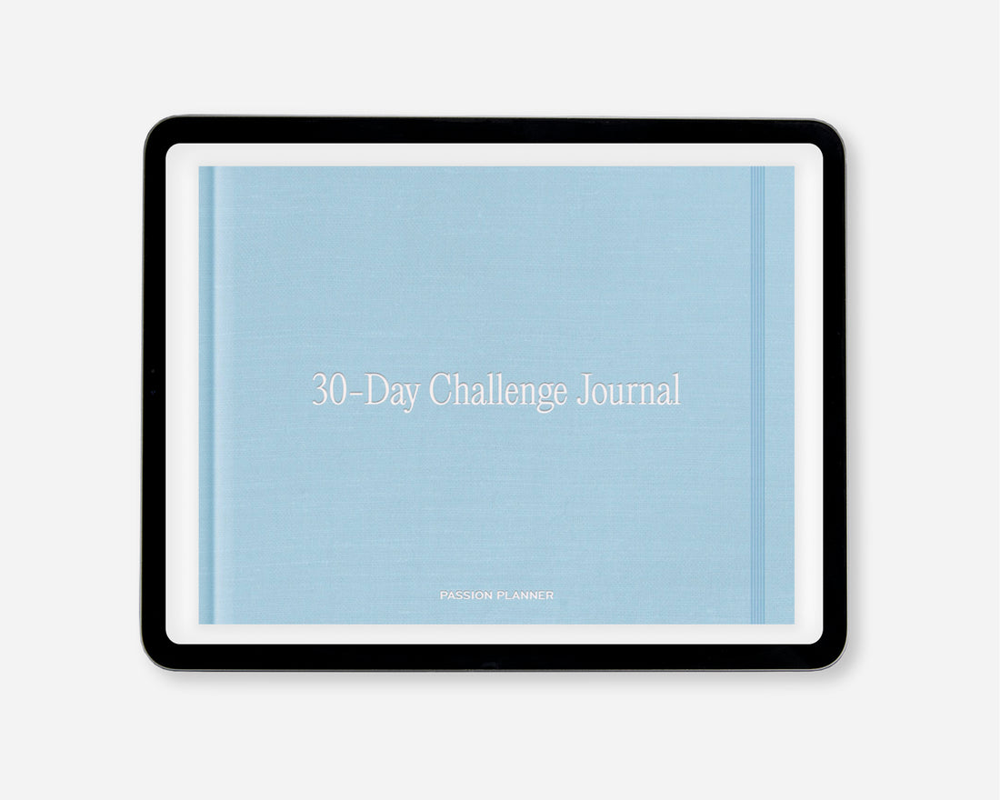 A 30-Day Challenge Journal by Passion Planner, featuring a light blue textured cover with white text, within a black tablet screen, shown on a light gray background.