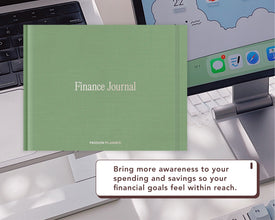 A sage green digital 'Finance Journal' by Passion Planner is displayed on a desk in front of a laptop and computer monitor, with a promotional text bubble at the bottom.