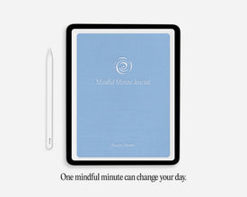 A tablet-style digital journal cover with a light blue front and black border, shown on a light gray background with a white stylus beside it and the text 'One mindful minute can change your day.' below.