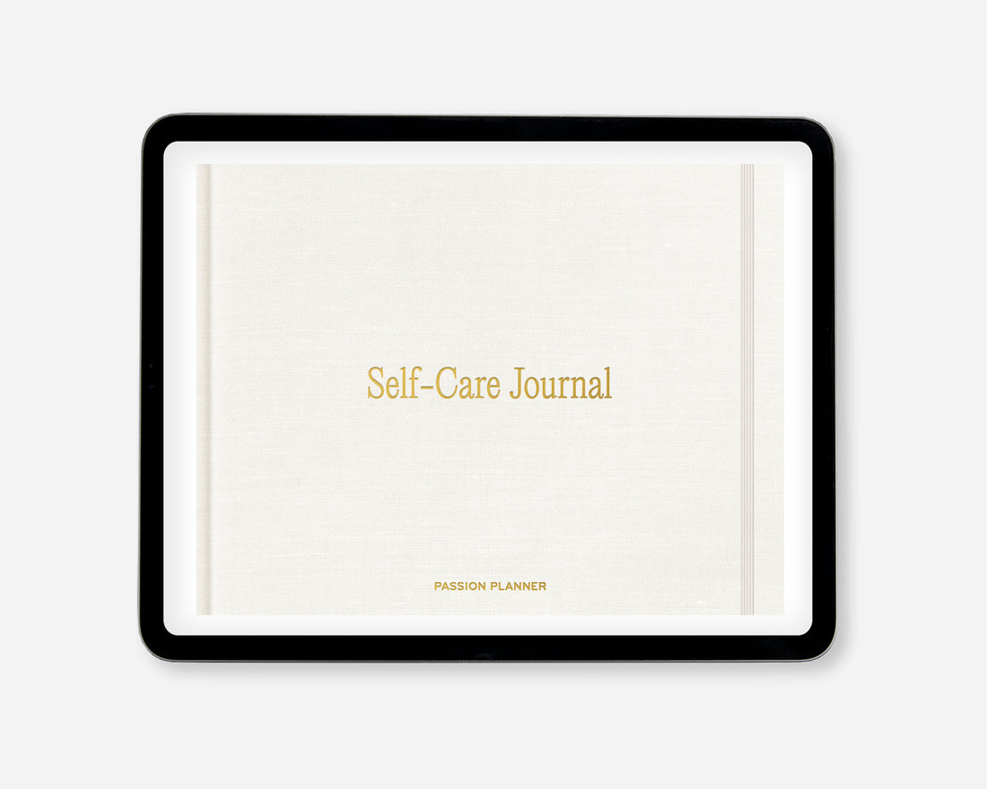 A digital self-care journal with a white cover shown on a tablet screen and gold text reading &