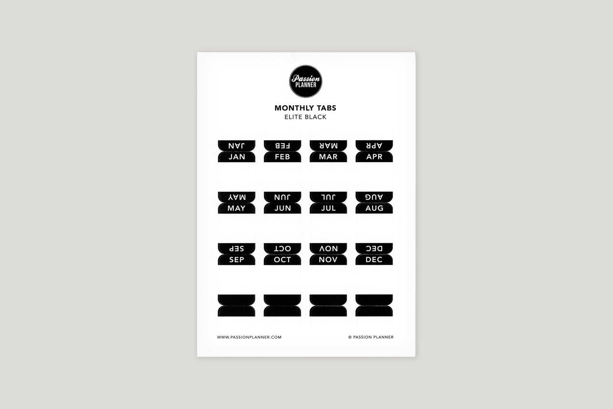 A sheet of black monthly tabs labeled with different months of the year, designed to be used in a planner.